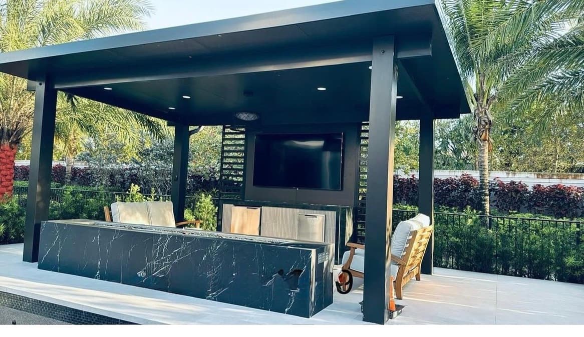 Black outdoor kitchen pergola with marble counter and built-in grill