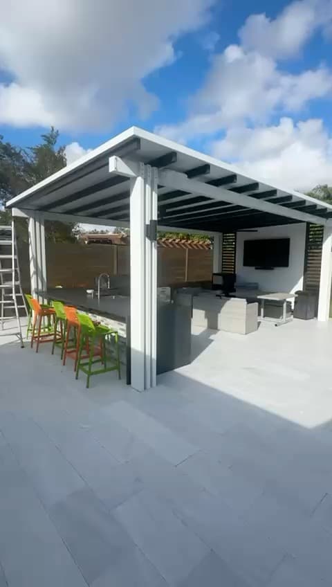 Outdoor kitchen with pergola and pool area