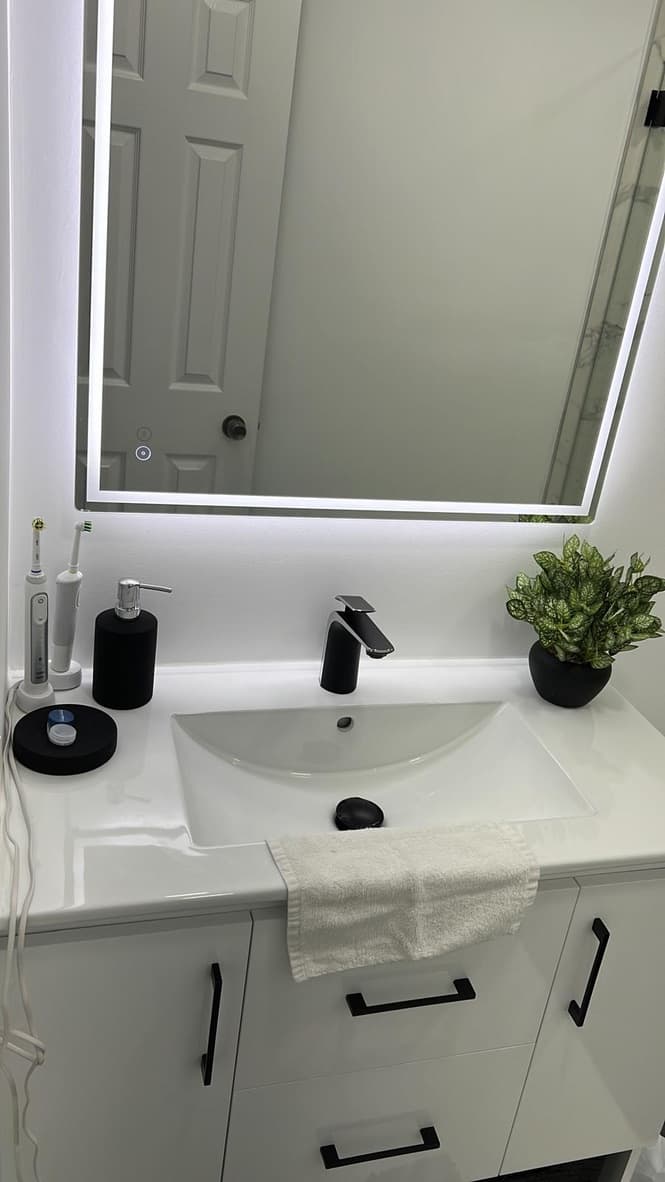 Marble shower with black fixtures and glass enclosure